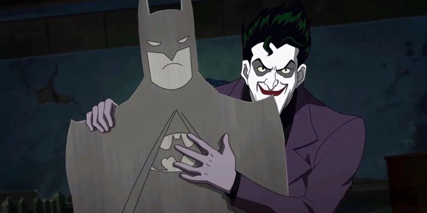 Joker clutching cardboard cutout of Batman