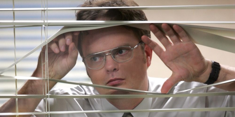 Dwight peering through the blinds on The Office