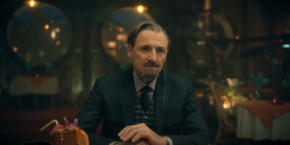  Reginald Hargreeves at a table in The Umbrella Academy