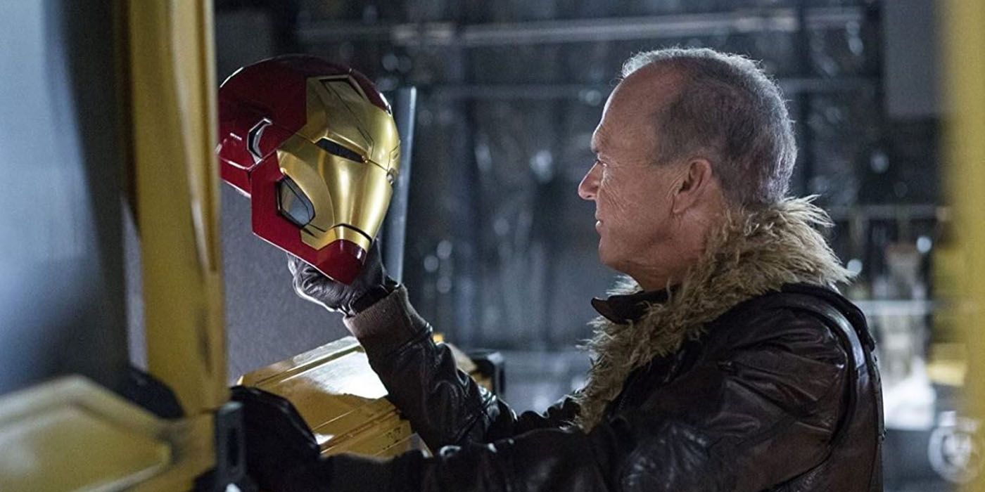 The Vulture holding up and looking at Iron Man&rsquo;s mask.