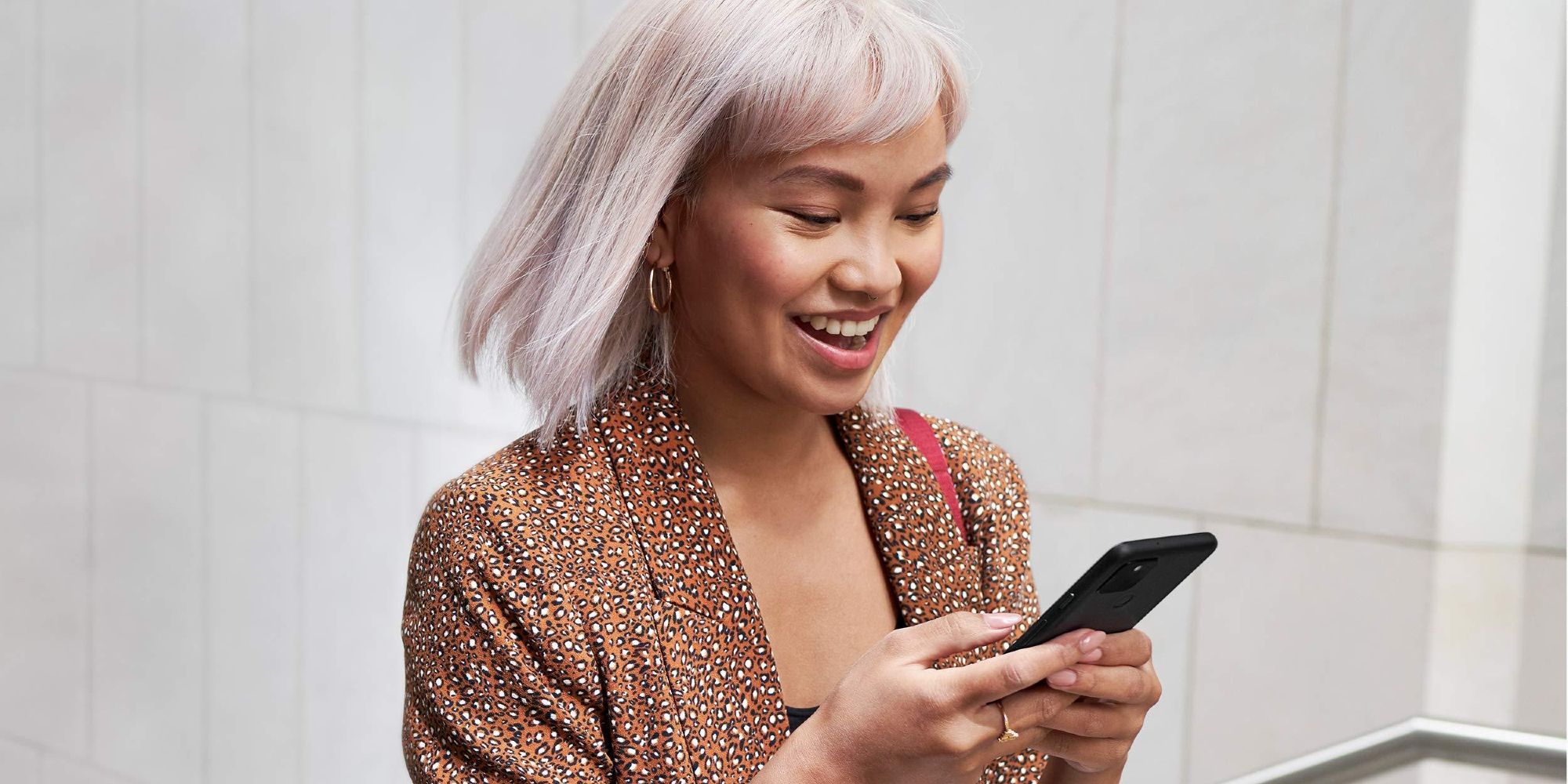 Woman smiling while using a Google Pixel 5