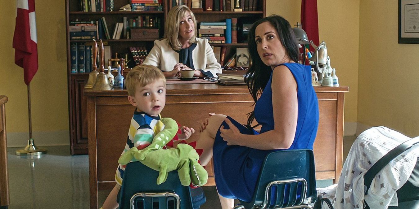Kate and her son at the principals' office on Workin' Moms