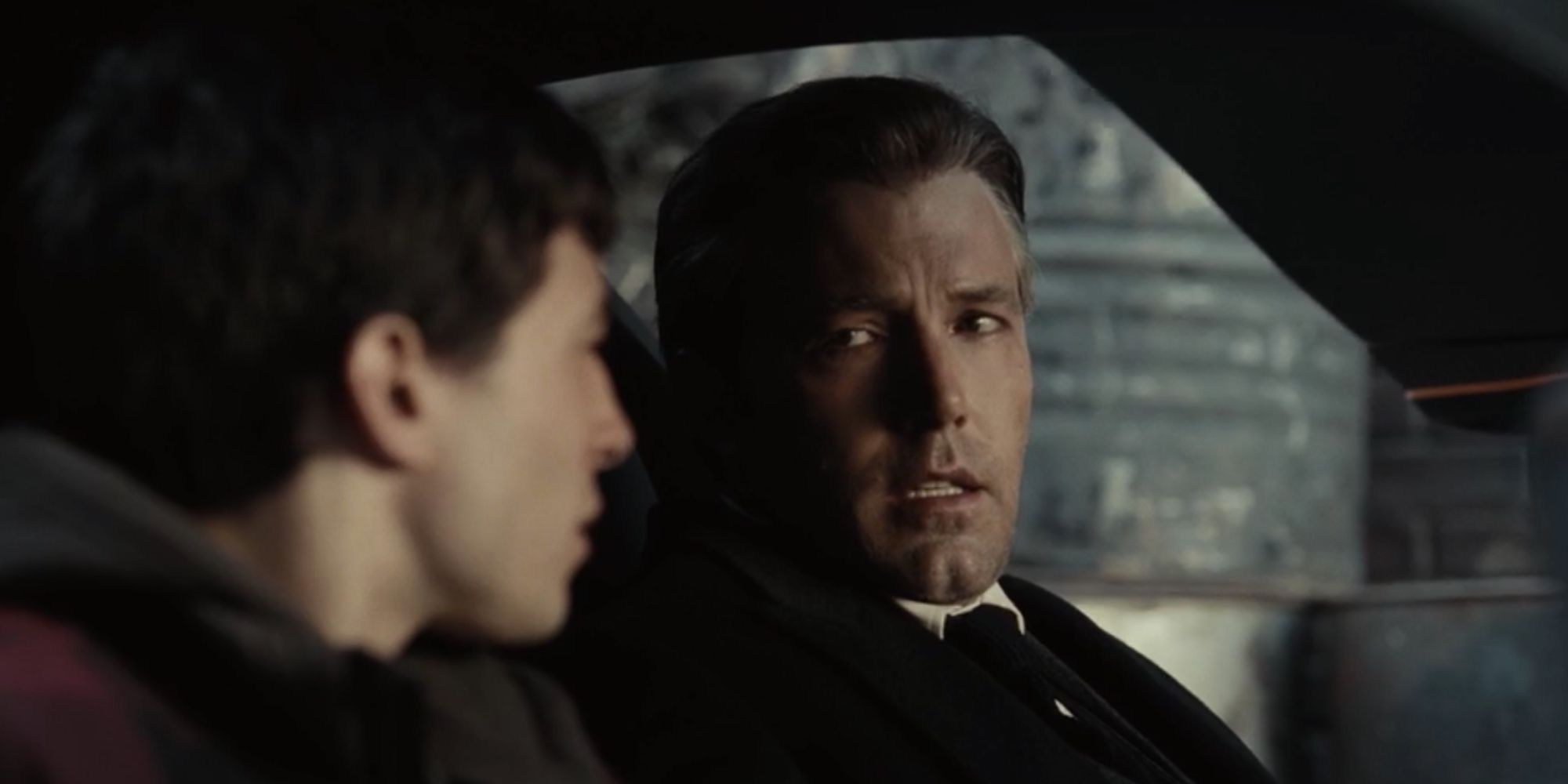 Bruce Wayne (Ben Affleck) sitting in his car with Barry Allen (Ezra Miller)