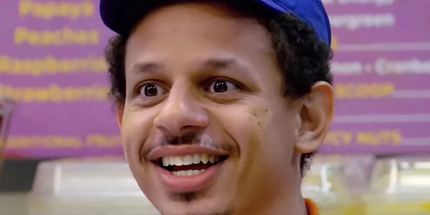 Close up of Eric Andre as Chris in Bad Trip wearing a baseball cap with a goofy smile