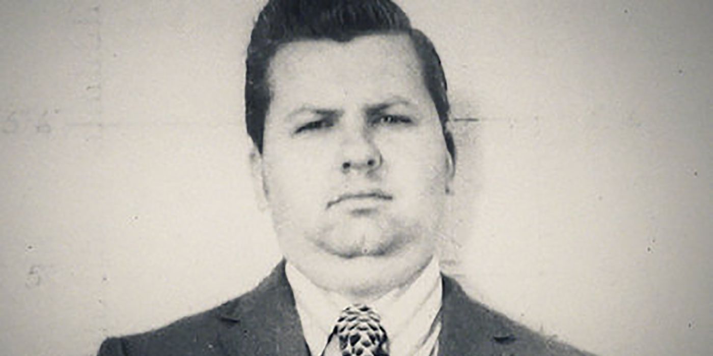 Younger black and white photo of John Wayne Gacy wearing a suit