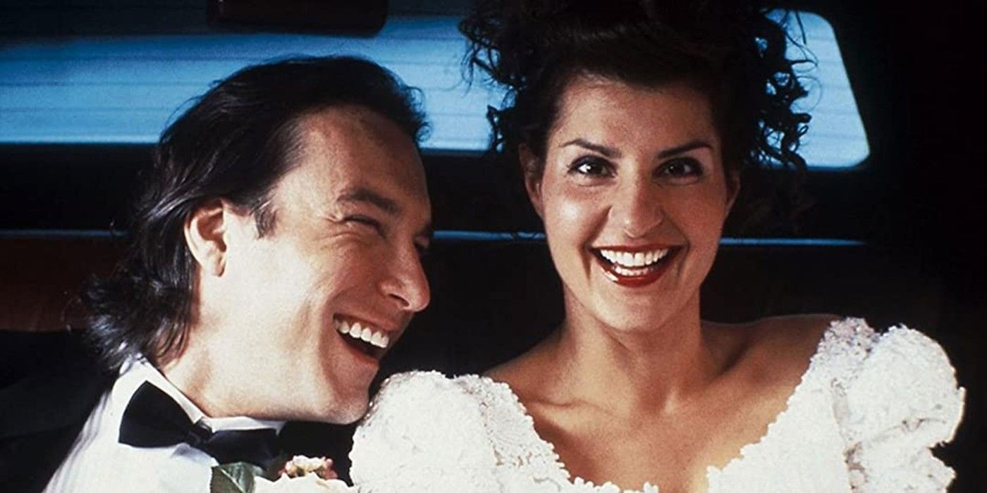 Ian and Toula laughing in a car after their wedding in My Big Fat Greek Wedding