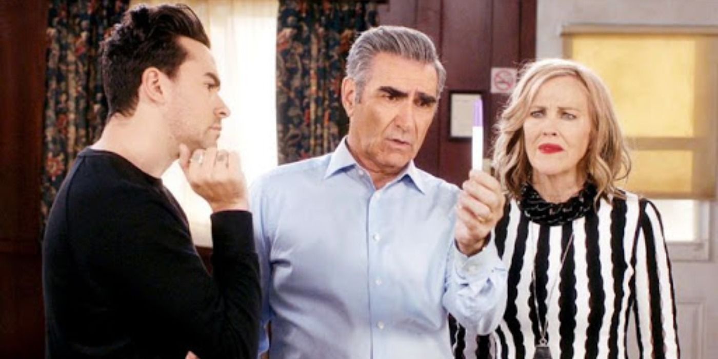 David, Johnny and Moira staring at a pregnancy test in Schitt's Creek