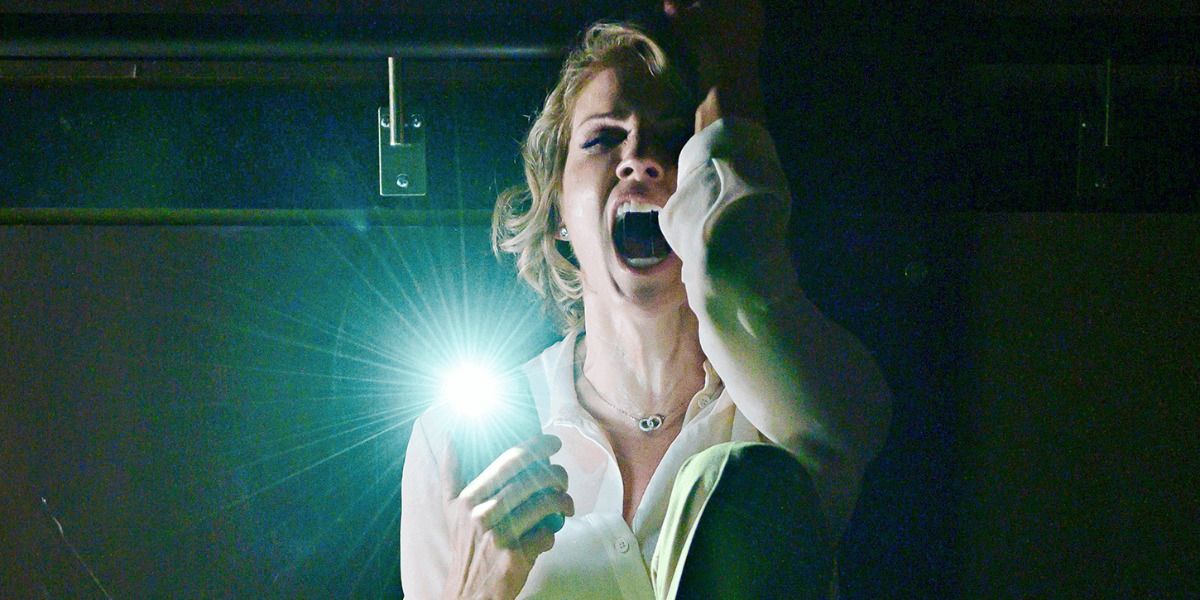 Tricia Helfer screams in green lit room in Creepshow reboot