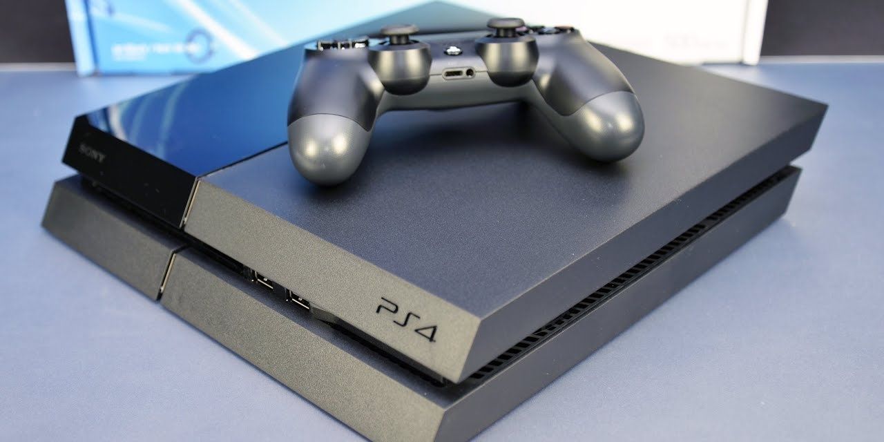 A picture of a black PS4 and controller