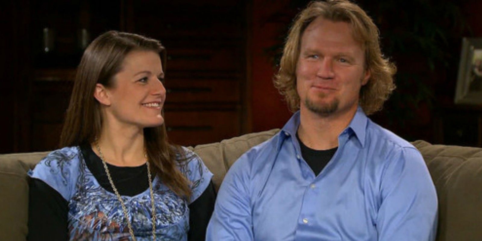 Kody and Robyn from Sister Wives smiling and sitting on couch