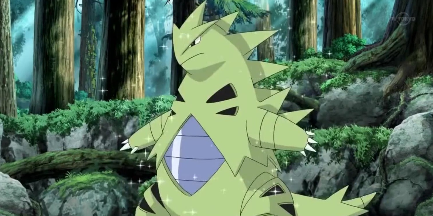 Tyranitar standing in the woods in the Pokémon anime
