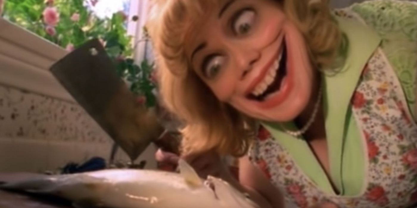 A woman grinning and cutting a fish in a still from the video for Black Hole Sun