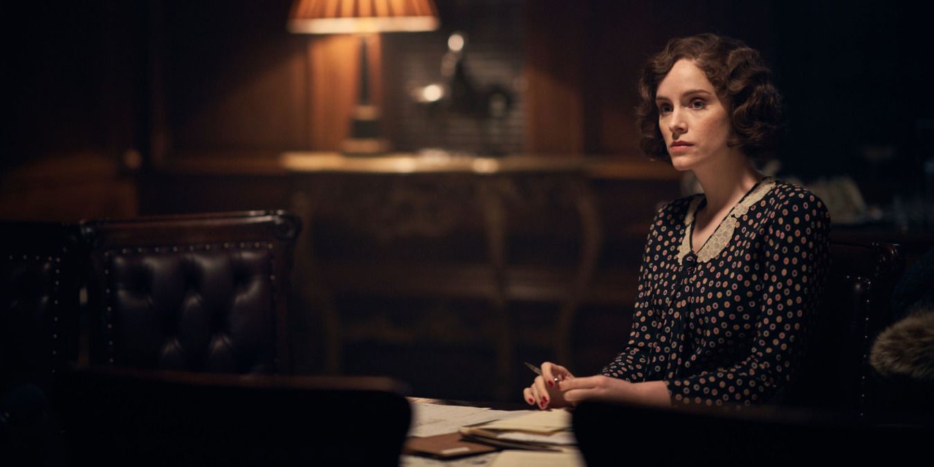 Ada Shelby from Peaky Blinders in the office of their business at night, doing paperwork