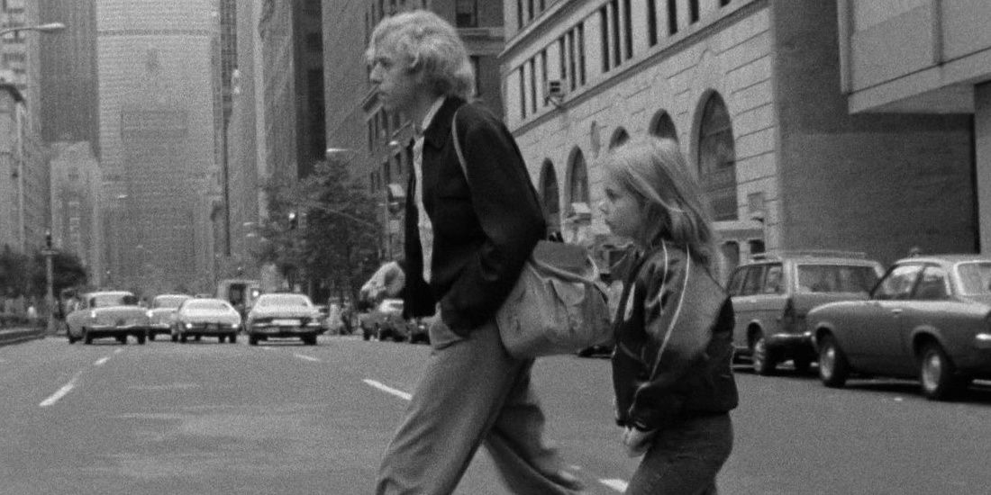 Alice and Philip crossing a road in a still from Alice In The Cities 