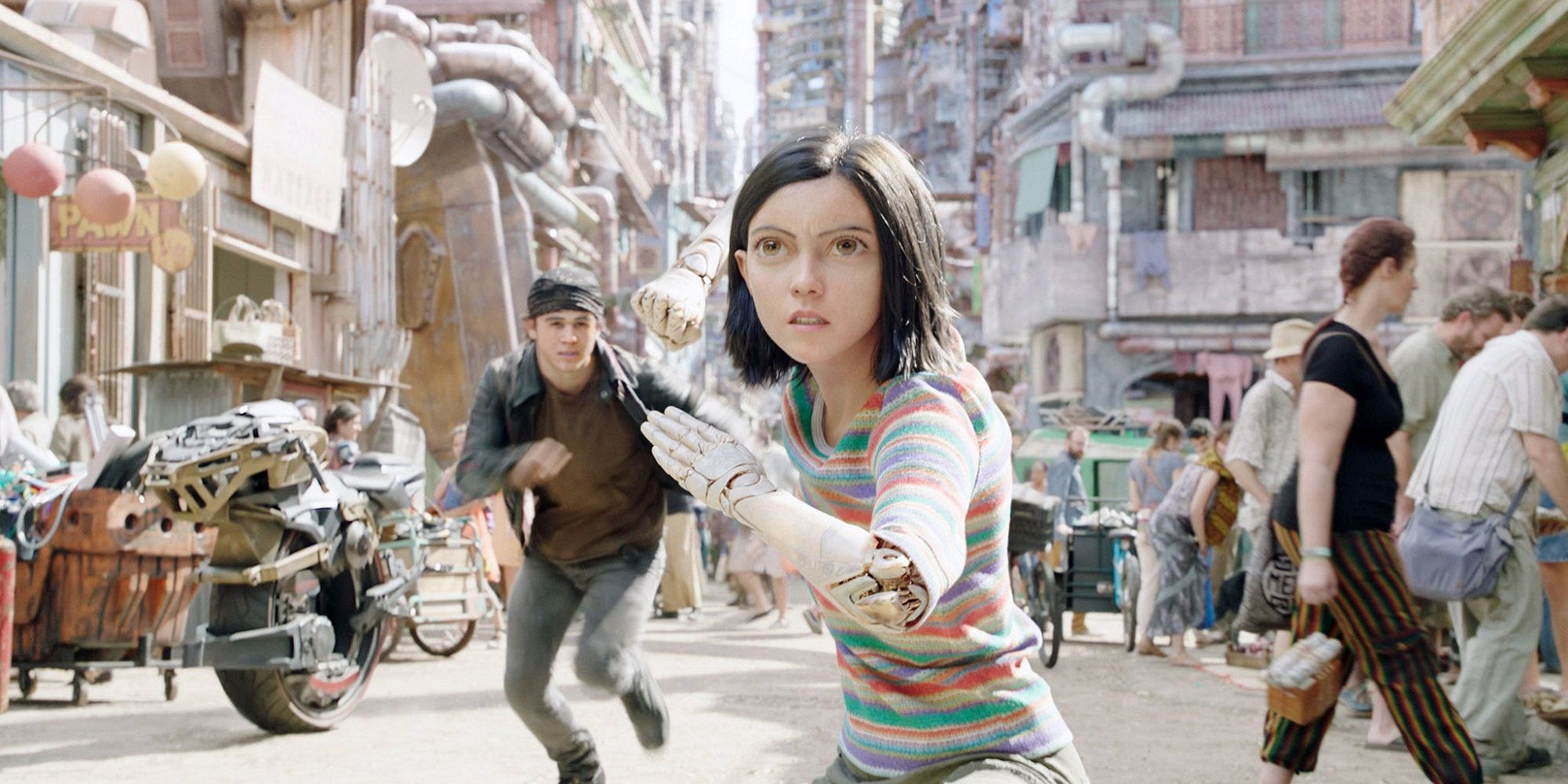Alita Battle Angel running through a market