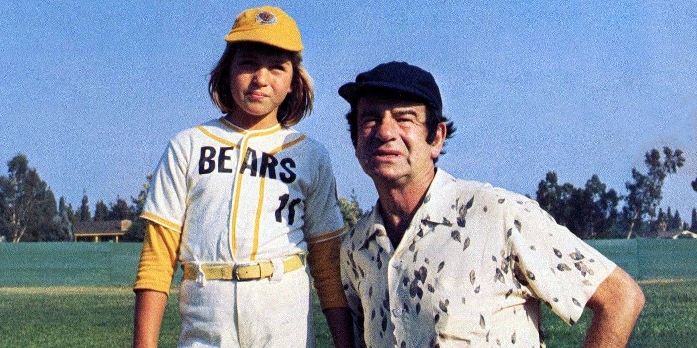 Amanda and Buttermaker on the baseball field in Bad News Bears