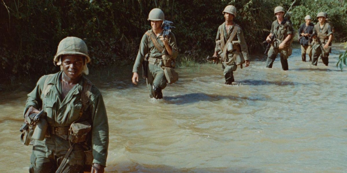 American soldiers crossing a river in Vietnam, a still from The Vietnam War 
