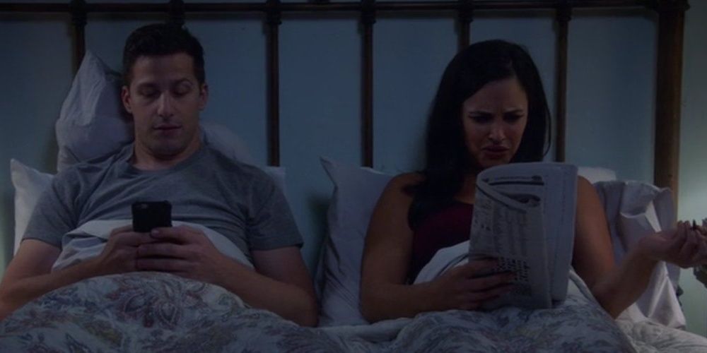 Jake and Amy in bed.
