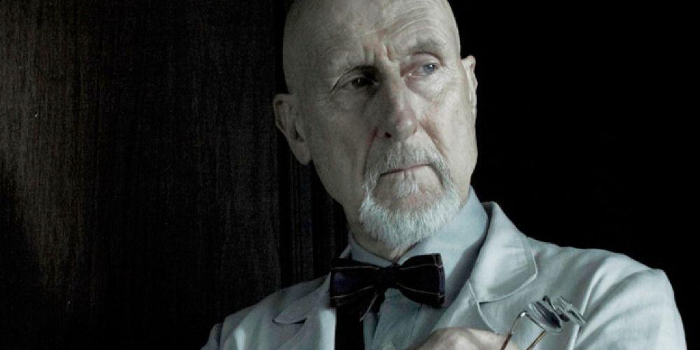 Dr Arthur Arden looking at something off-screen in a scene from AHS