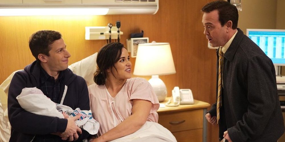 Jake and Amy with their baby, talking to Charles.