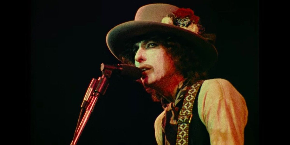 Bob Dylan performing on stage in makeup, a still from Renaldo and Clara