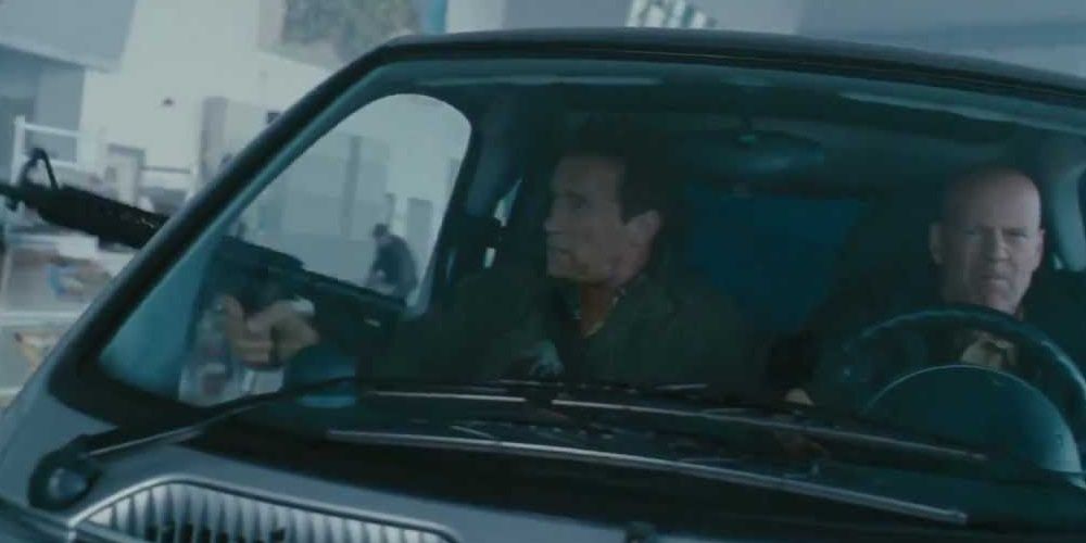 Bruce Willis and Arnold Schwarzenneger shooting in a smart car