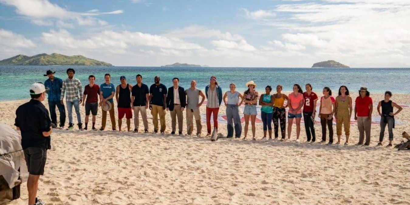Cast of season 40 standing in a line on the beach