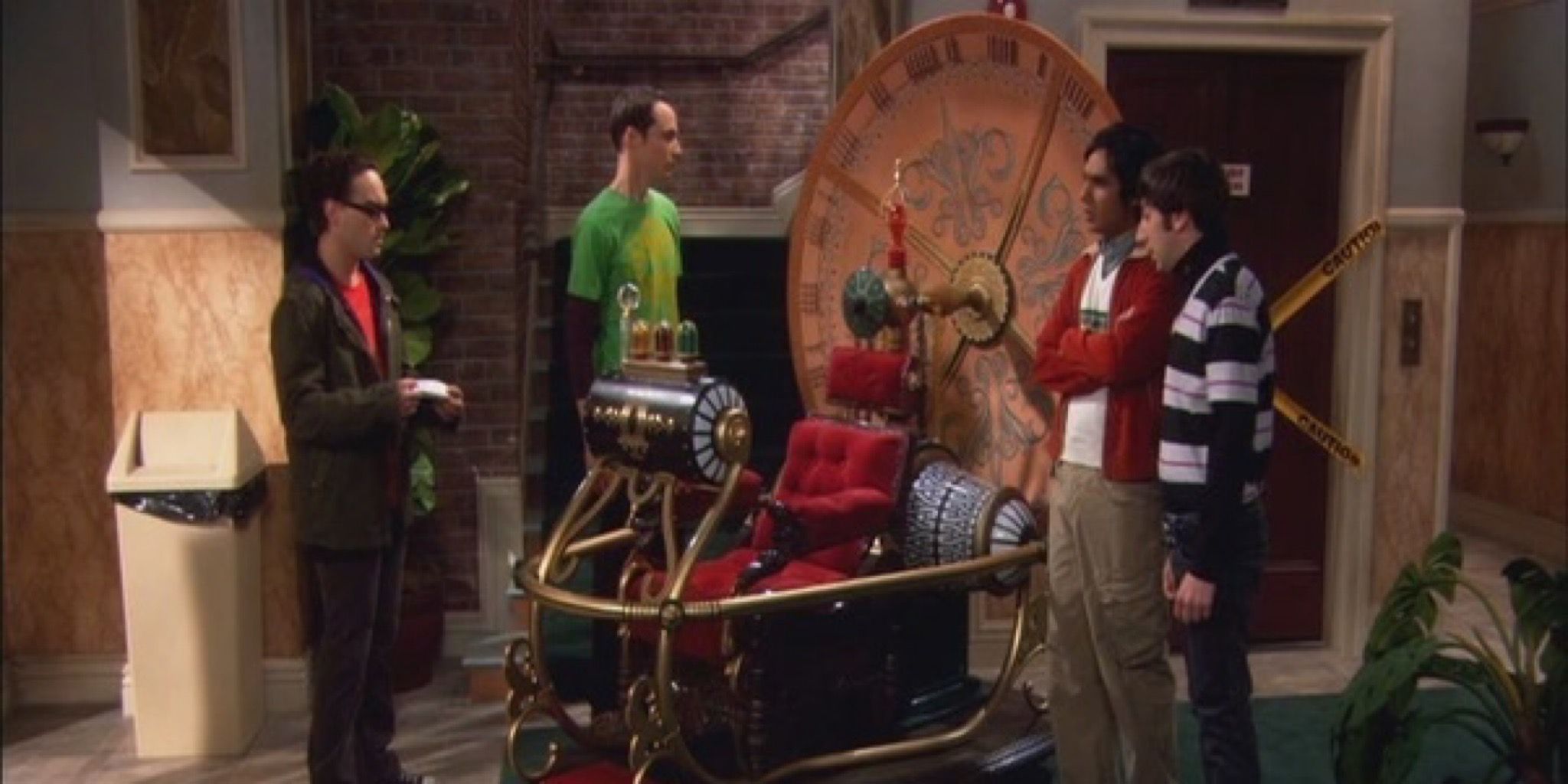 Leonard, Sheldon, Penny and Raj beside a time machine 