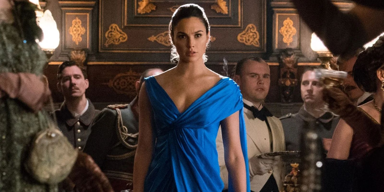 Diana Prince arrives at the party in a blue gown in Wonder Woman
