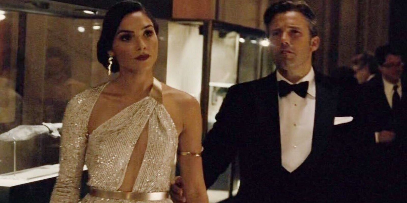 Diana Prince tries to avoid Bruce Wayne at a party in Batman v Superman