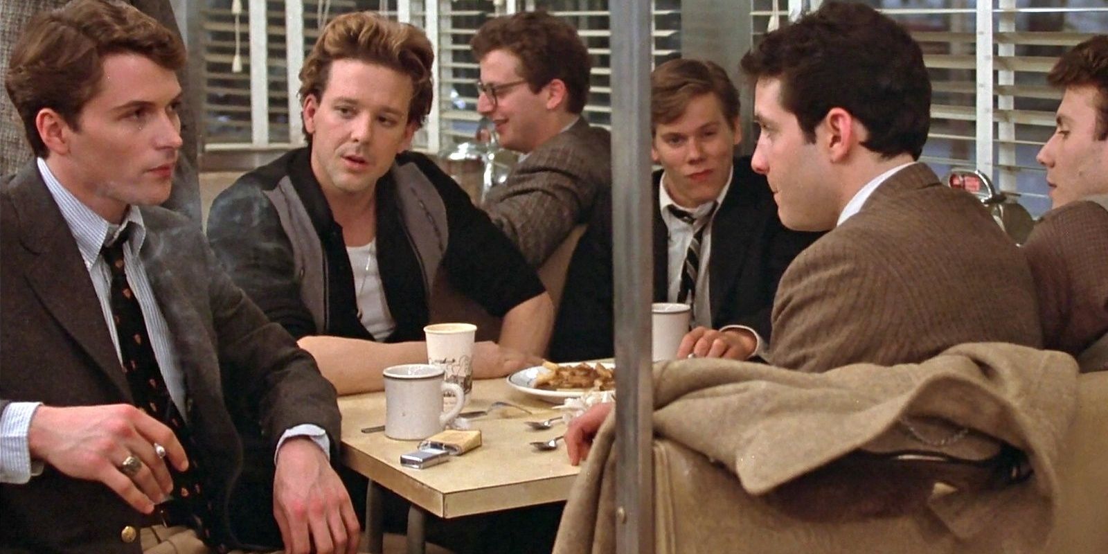 Mickey Rourke, Kevin Bacon, Daniel Stern at diner booth in Diner