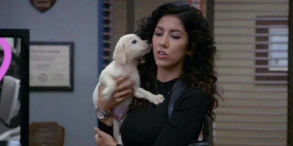 Rosa holding a puppy.