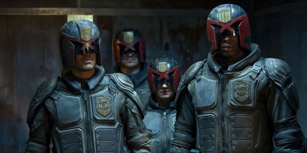 Judge Dredd and two other mercanaries standing in a group in Judge Dredd