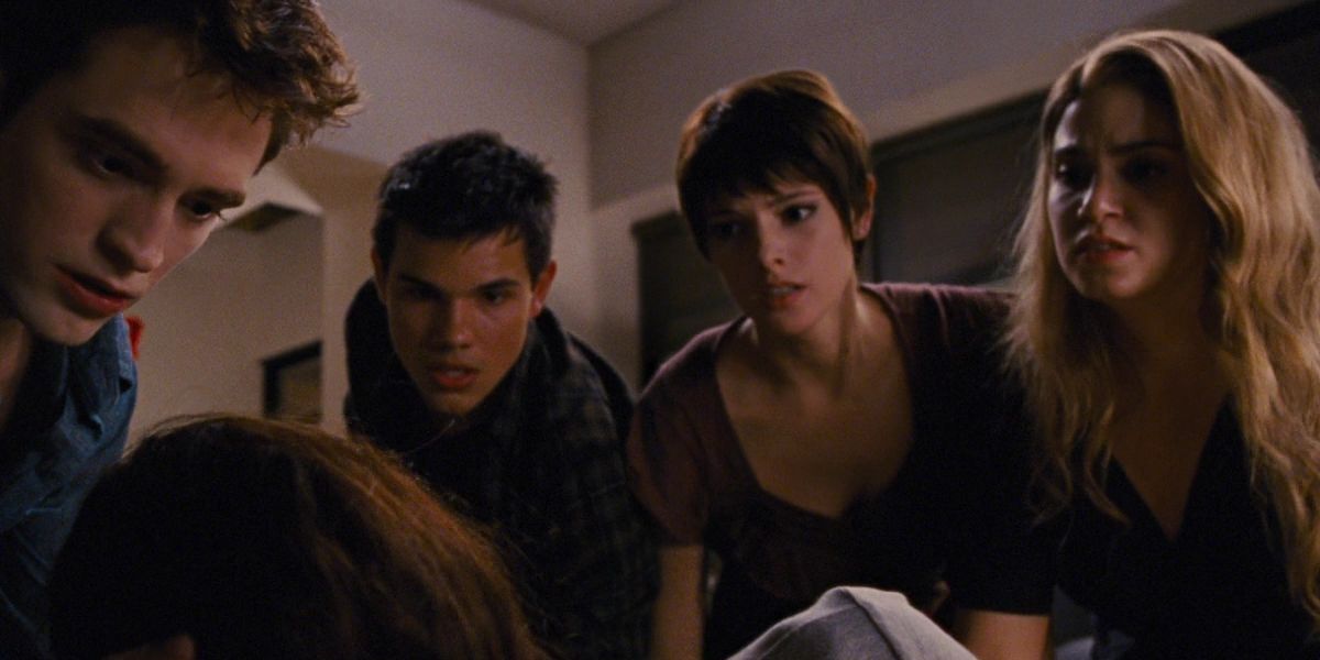 Edward, Jacob, Alice, and Rosalie looking at Bella on the floor