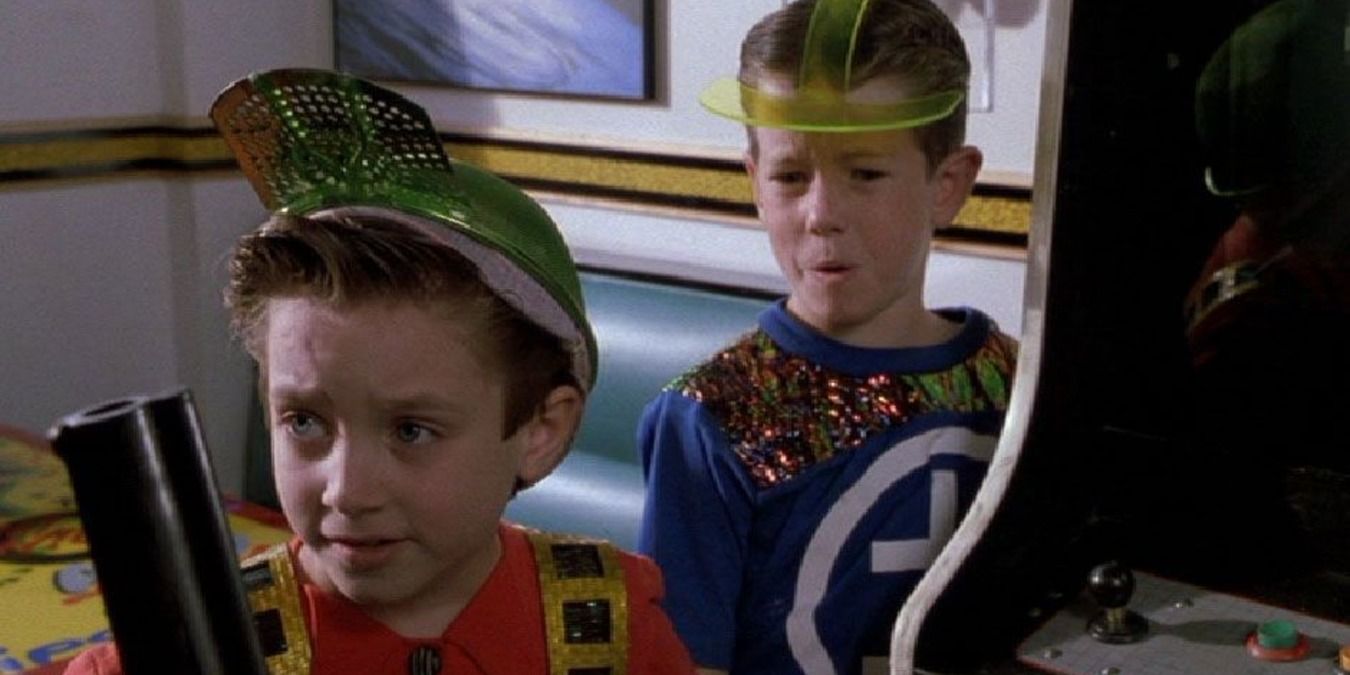 Elijah Wood as a young boy in Back to the Future II, playing a video game with his friend