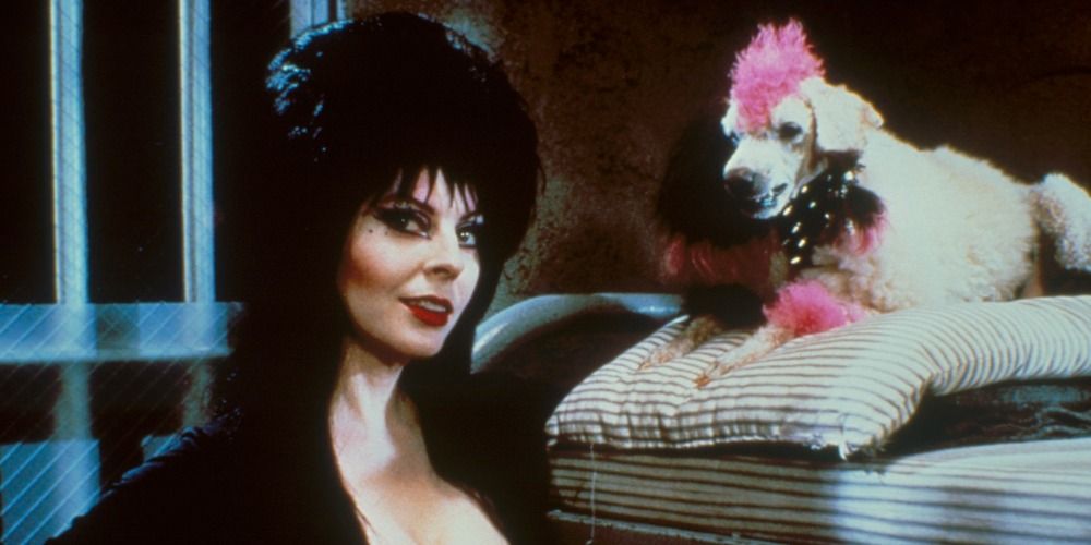 Elvira posing and standing next to a fake poodle in Elvira: Mistress of Evil