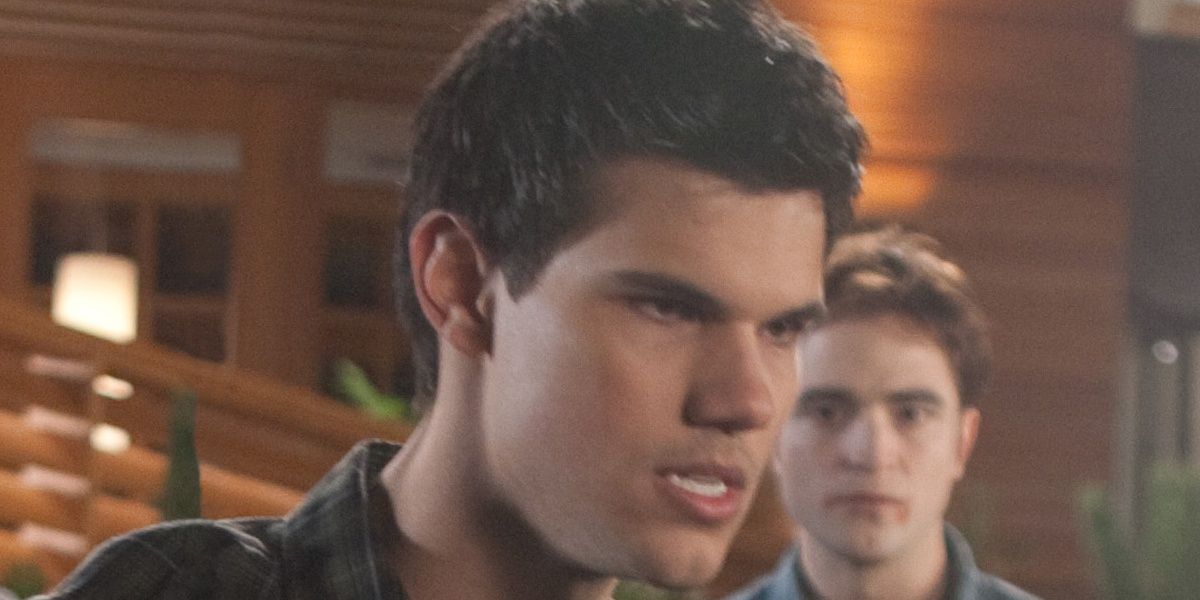 Jacob looking angry, Edward staring at him in the background