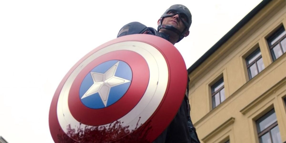 John holds the bloodied Captain America shield in Falcon and the Winter Soldier