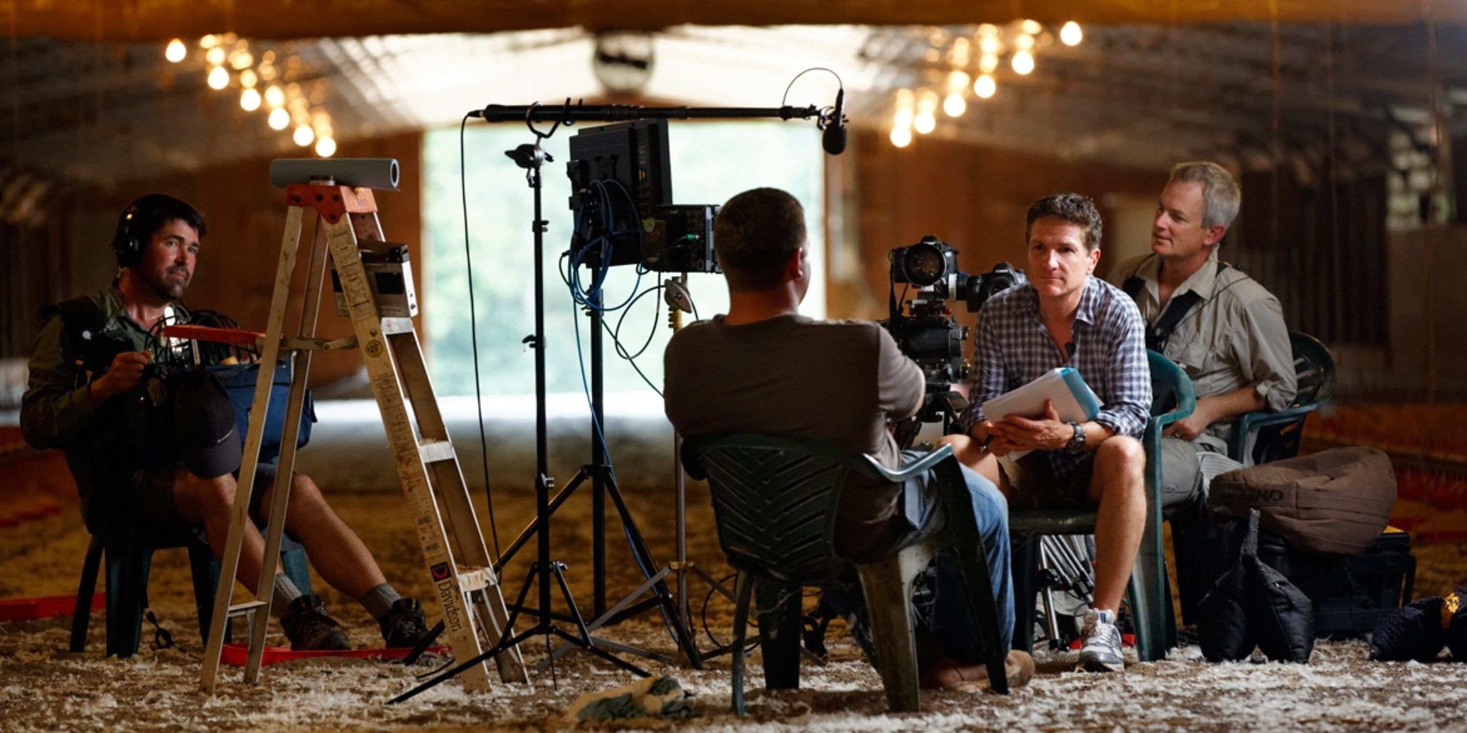 A rancher is interviewed in a barn