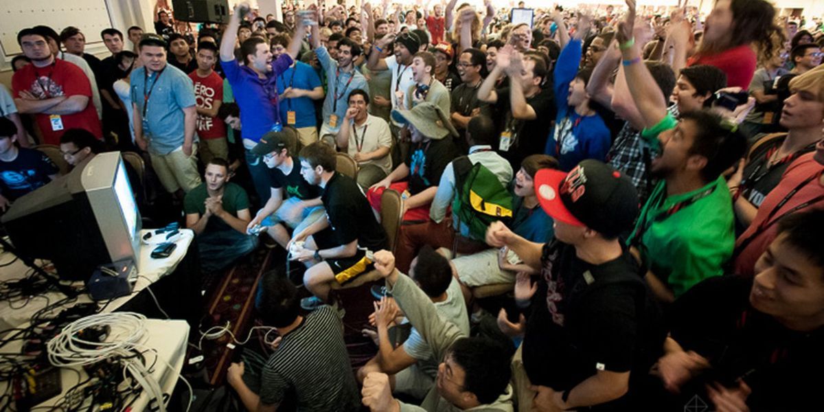 Huge crowd gathered around gamers during competition.