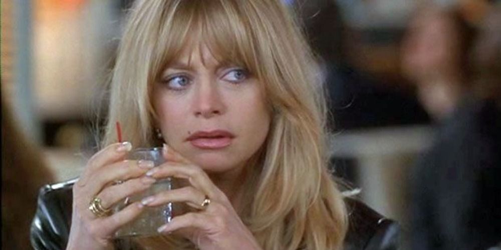 Elise Elliot Atchison holding a drink and looking at something off-camera in First Wives Club