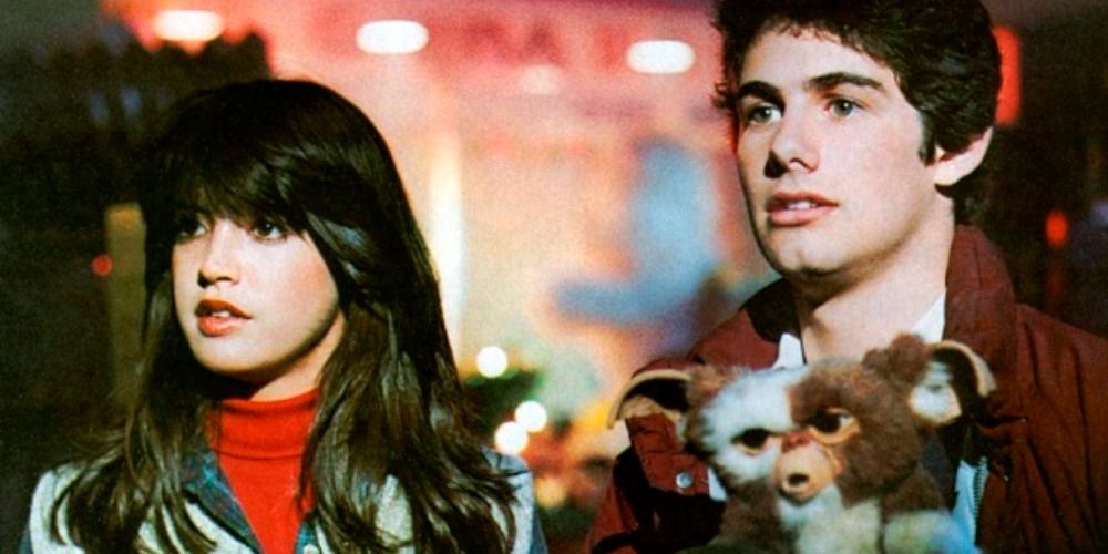 Scene from the Gremlins with Zach Galligan and Phoebe Cates holding a Gremlin