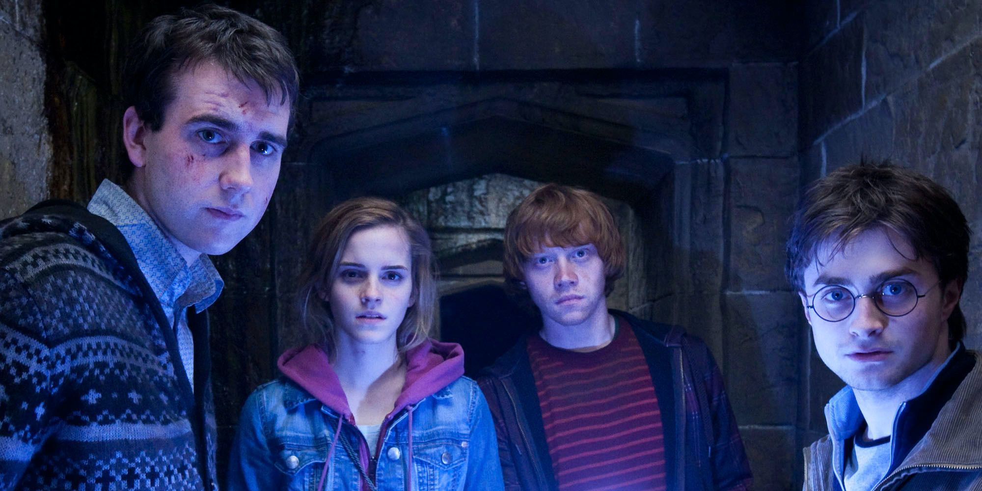 Neville leads Hermione, Ron, and Harry down the secret passage to the Room of Requirement in Harry Potter and the Deathly Hallows Part 2 