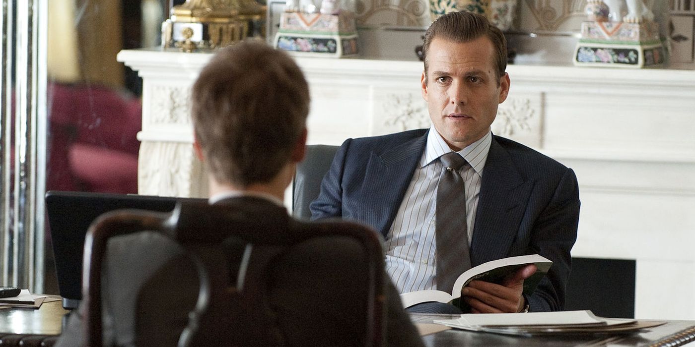 Mike sitting across from Harvey in a scene from Suits.