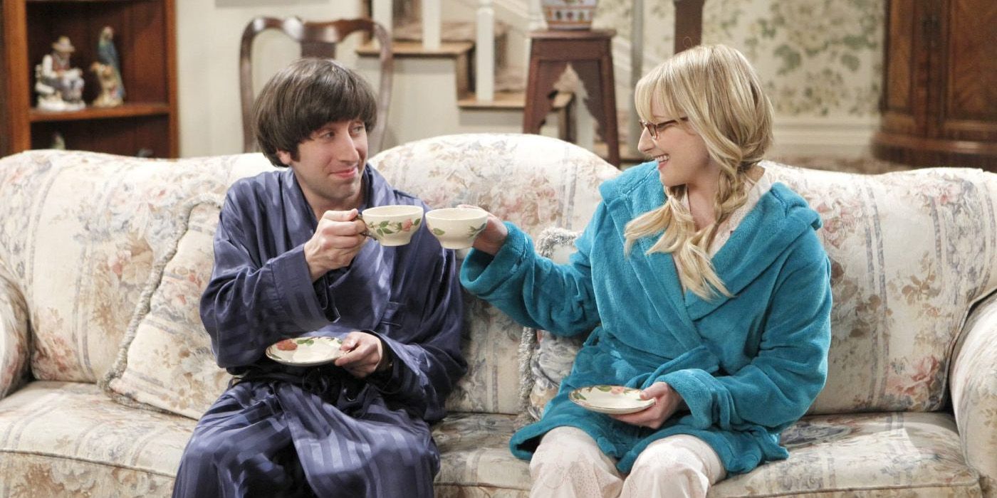 Howard and Bernadette toasting with cups of tea in The Big Bang Theory