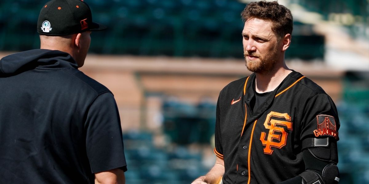 Hunter Pence talking to a man while in a baseball field