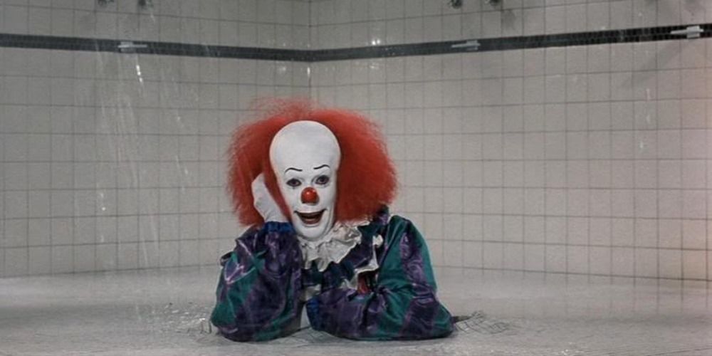 Pennywise smiling after he emerges from the shower drain