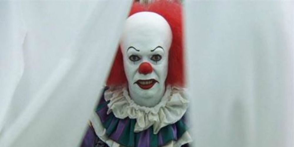 Pennywise staring through sheets blowing in the wind