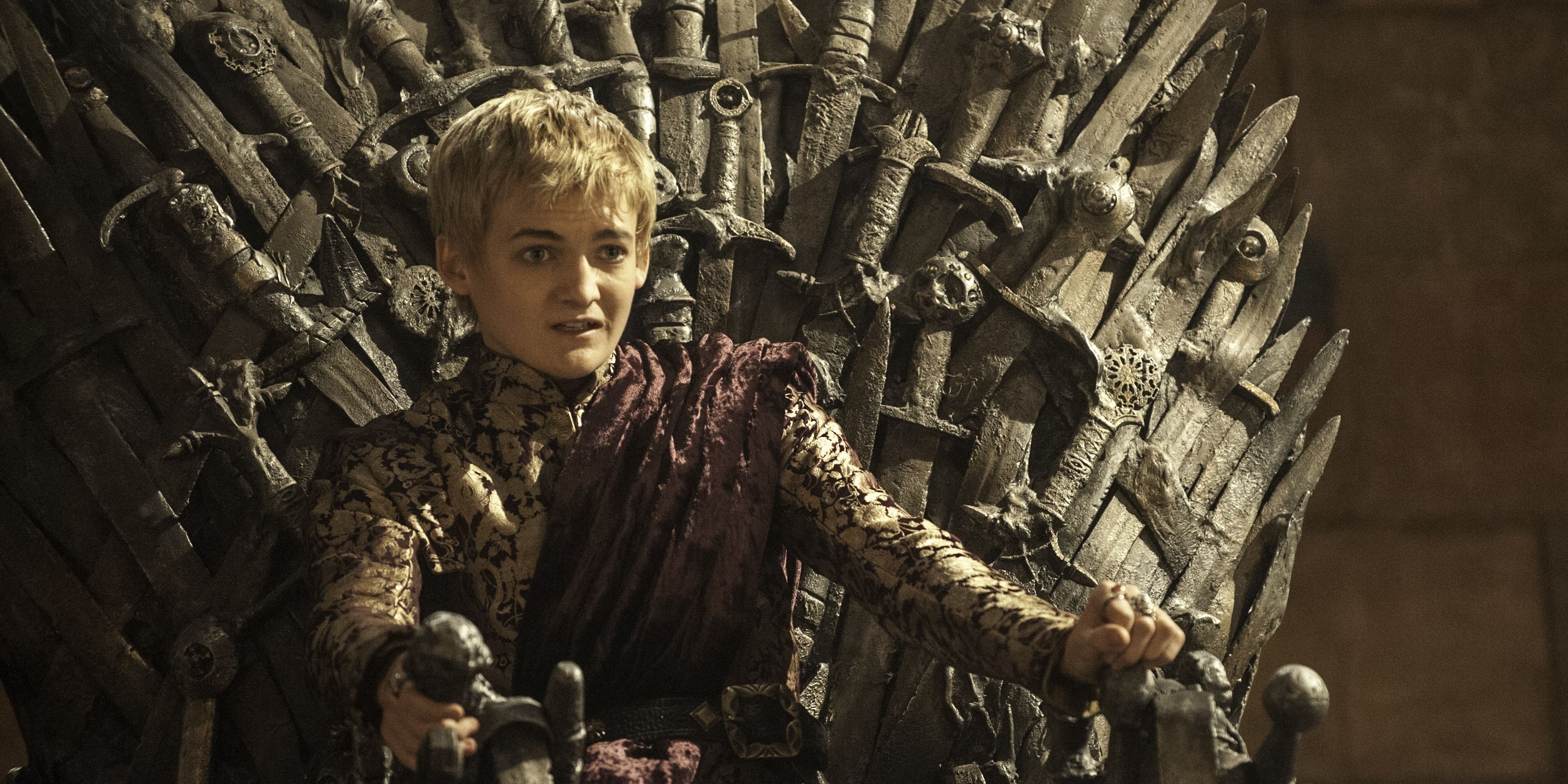 Jack Gleeson as Joffrey Baratheon in Game of Thrones sitting on the Iron Throne