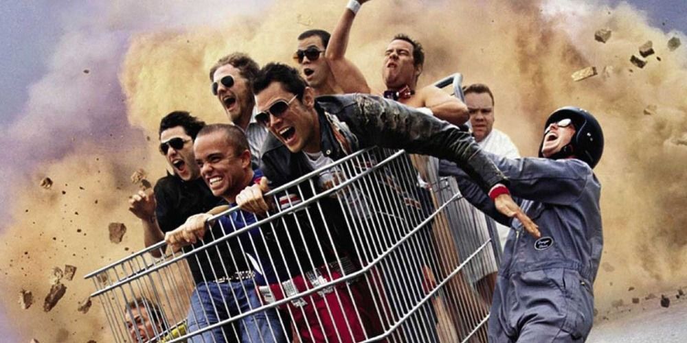 Johnny Knoxville, Bam, Ryan, Steve-O, and Wee Man in a shopping cart in front of an explosion